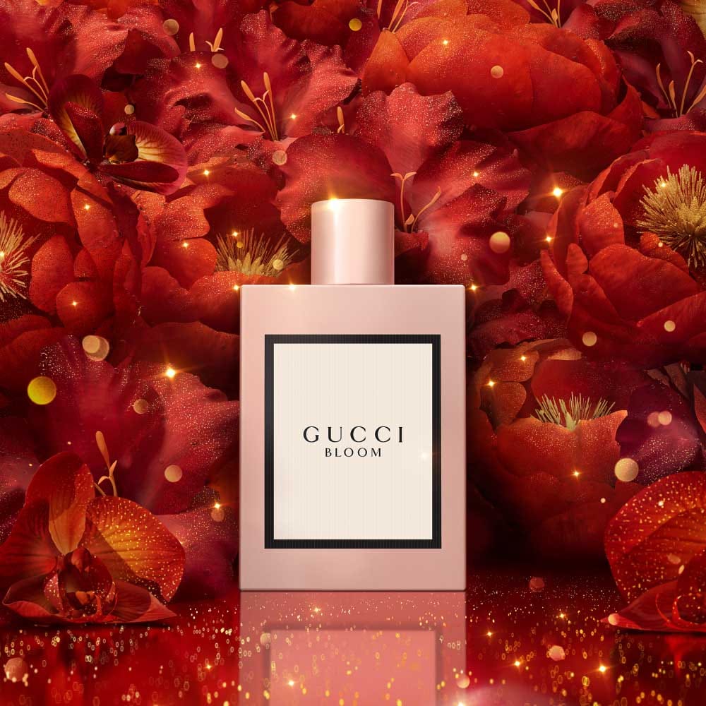 Gucci Bloom Fragrance product with red flowers backdrop