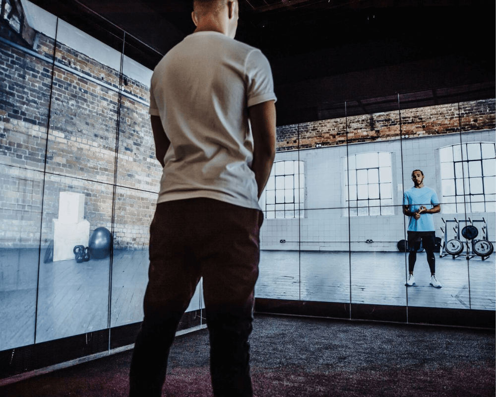 Person within the Sjill Cube immersive experience being trained by Lewis Hamilton